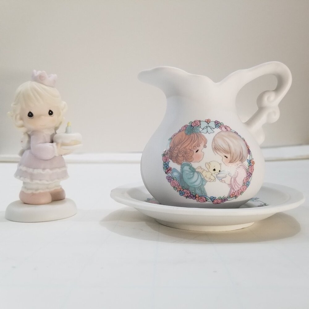 Precious Moements. One tea set and the other is a birthday girl